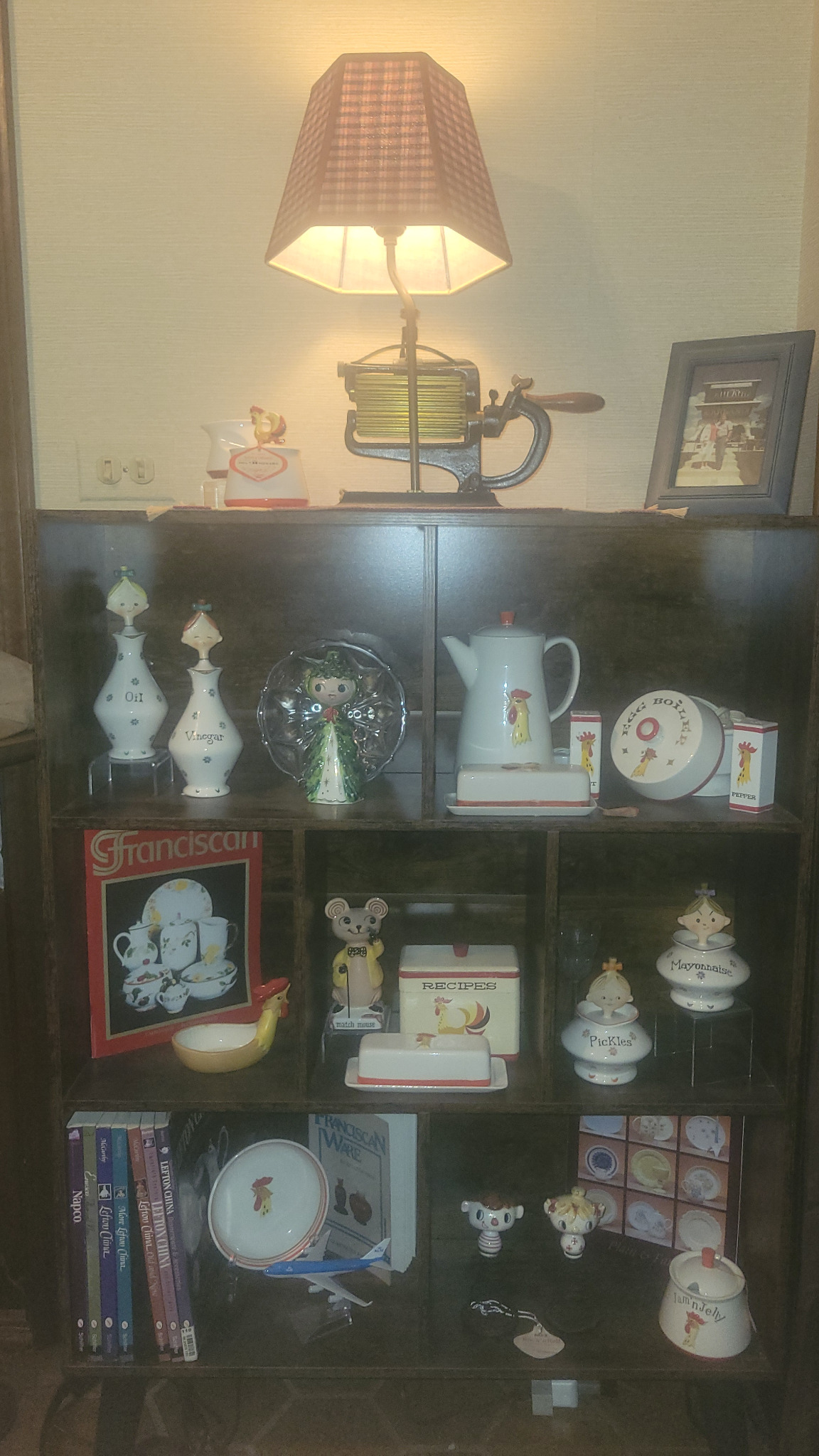 Foyer stair landing shelves with Holt Howard ceramics and reference books