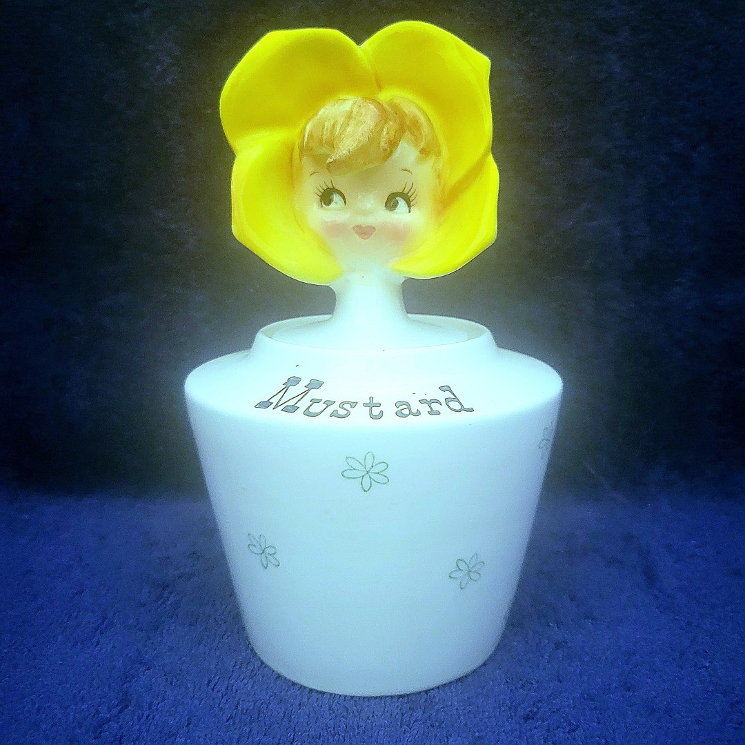 Mustard, with a yellow four-petaled flower bonnet.