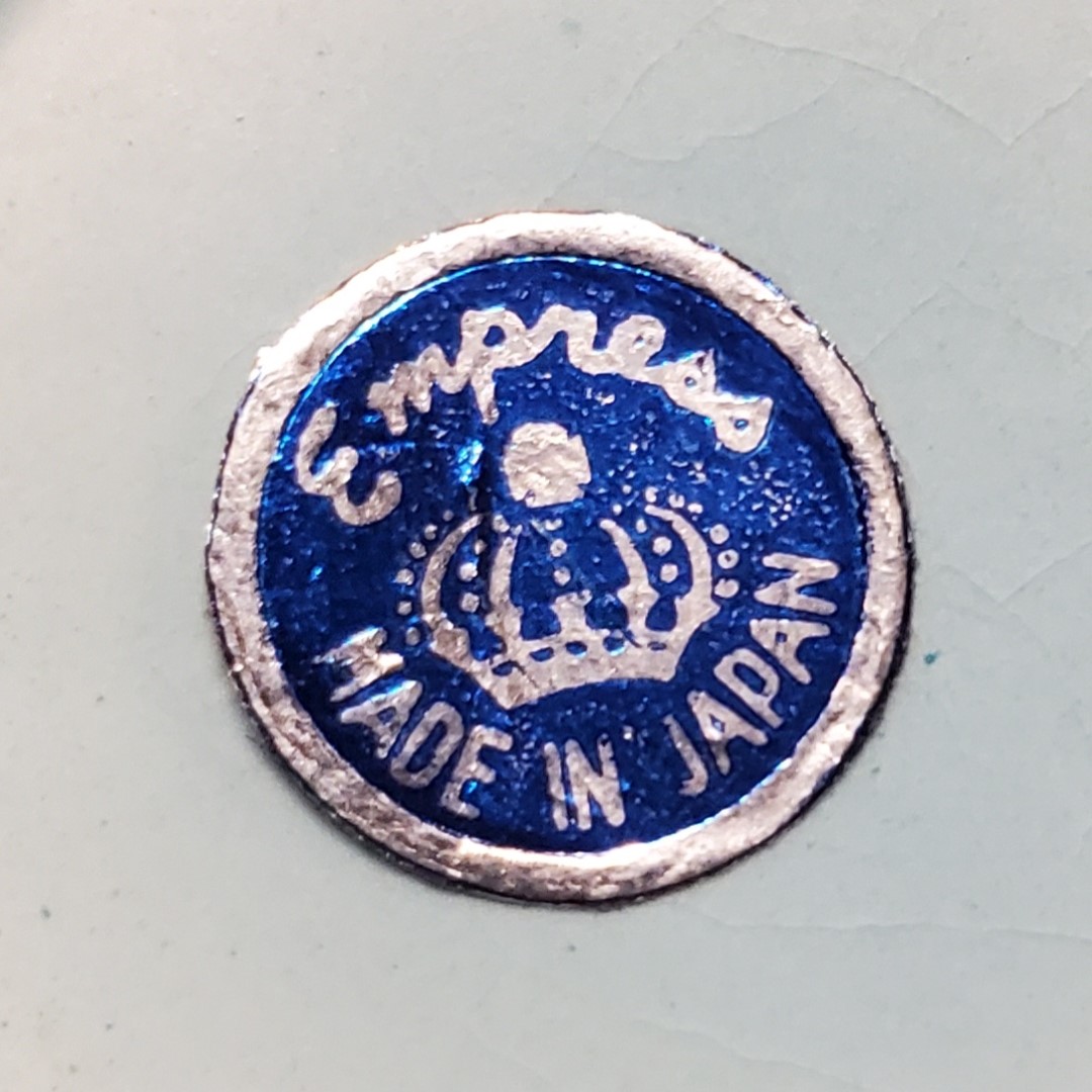Close-up of the round Empress Made in Japan label found on the Boy and Girl jars.