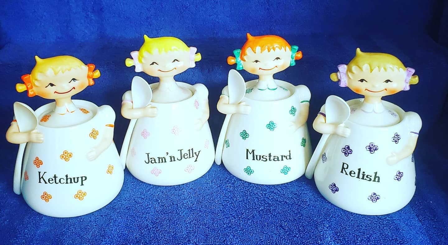 Four Norcrest girl jars together.