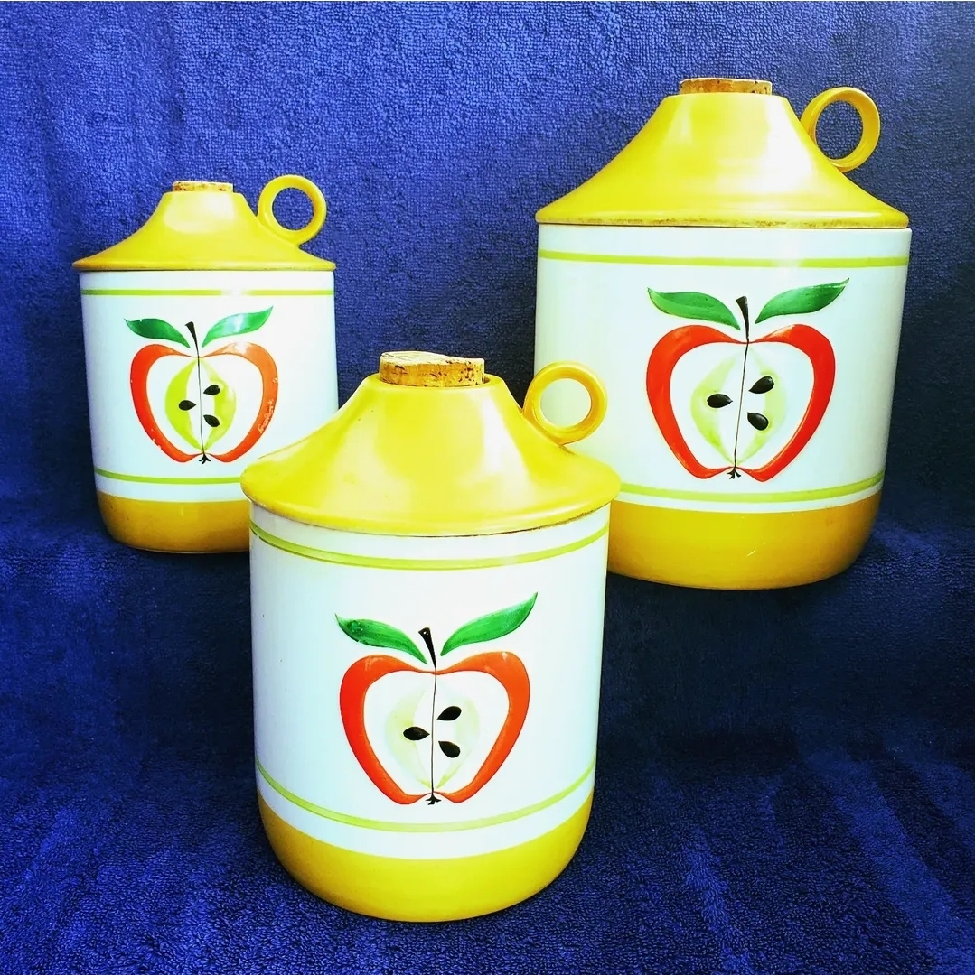 Three-piece ceramic canister set: cookie jar, medium canister, and small canister.