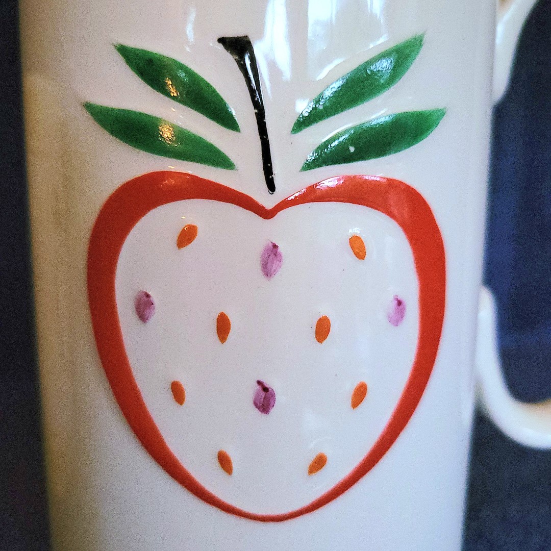 Close-up of strawberry decoration on coffee server.