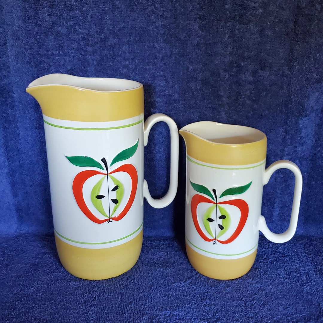 Large and small handled pitchers.