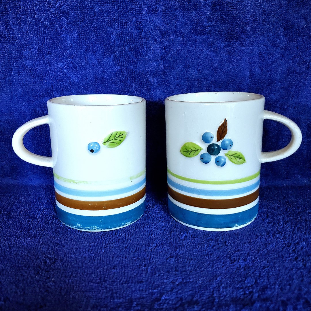Two Blueberry mugs turned to show both decorative sides.