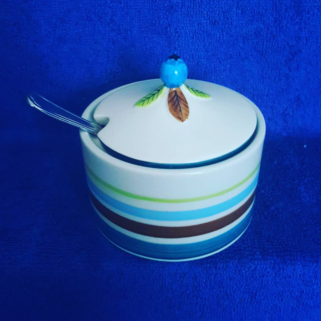 Blueberry Jam and Jelly jar with spoon in slotted lid.