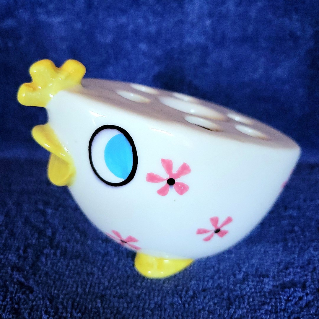 Side view of the Peepin' Tom and Tweetie candleholder flower frog
