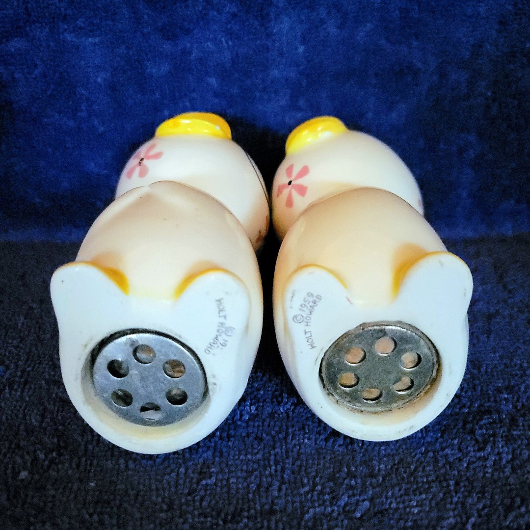 Undersides of the full-size salt and pepper shakers showing their noisemakers