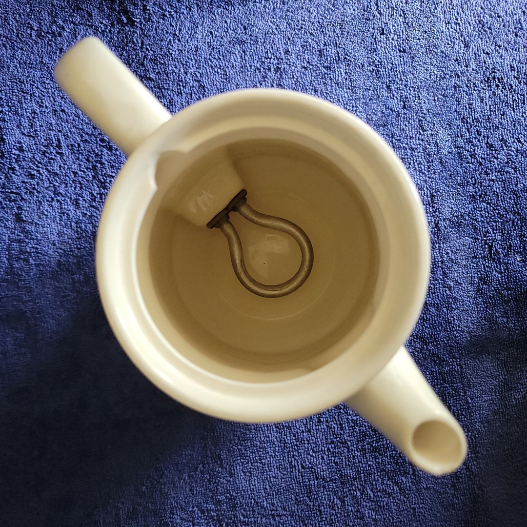 Interior of Coq Rouge electric hot pot showing heating element.