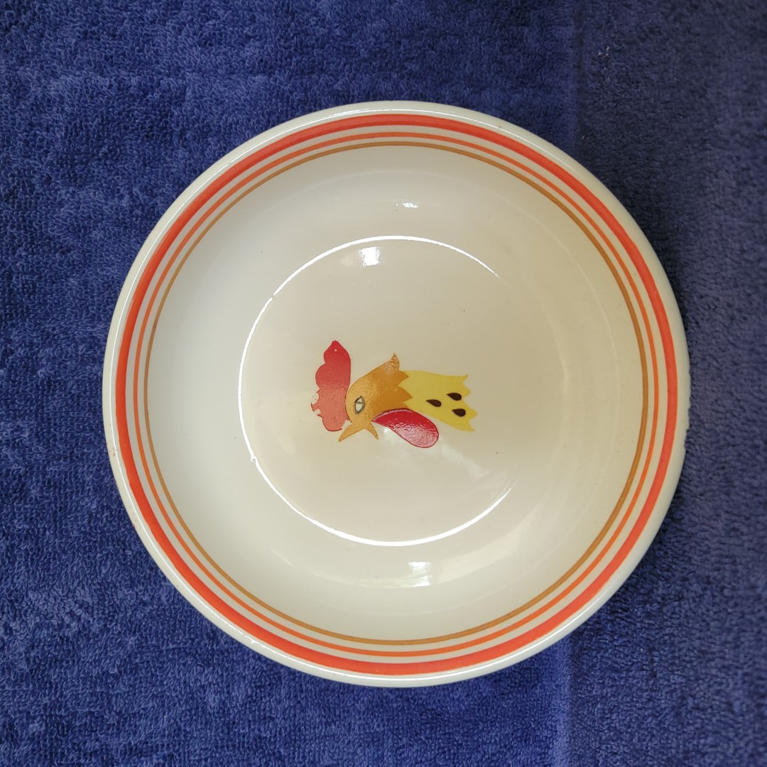 Holt Howard Coq Rouge cereal bowl with rooster-head decoration and striped rim.