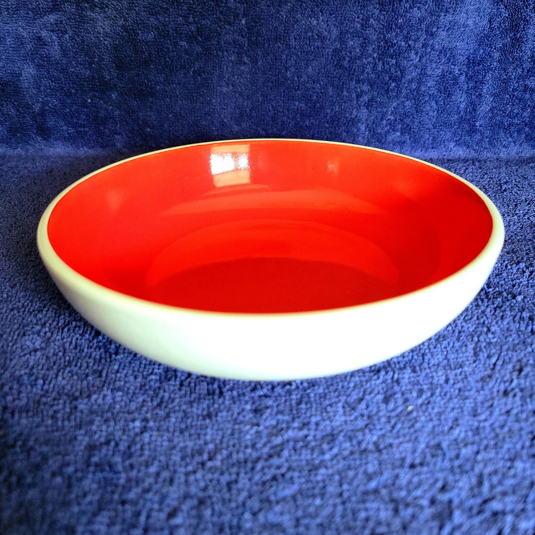 Side view of Holt Howard Coq Rouge red-interior bowl.