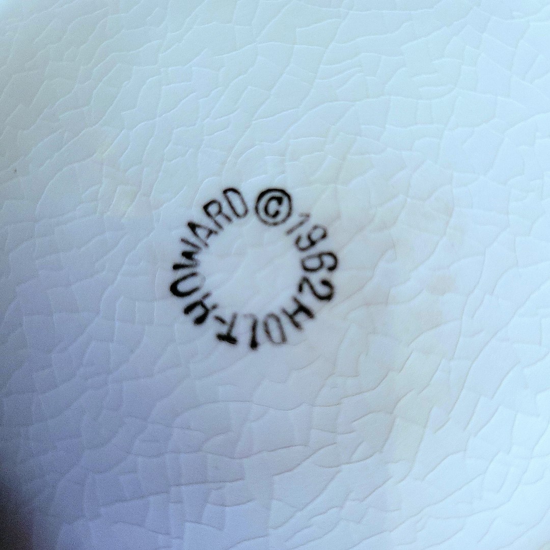 Close-up of 1962 Holt Howard backstamp on Coq Rouge red-interior bowl.