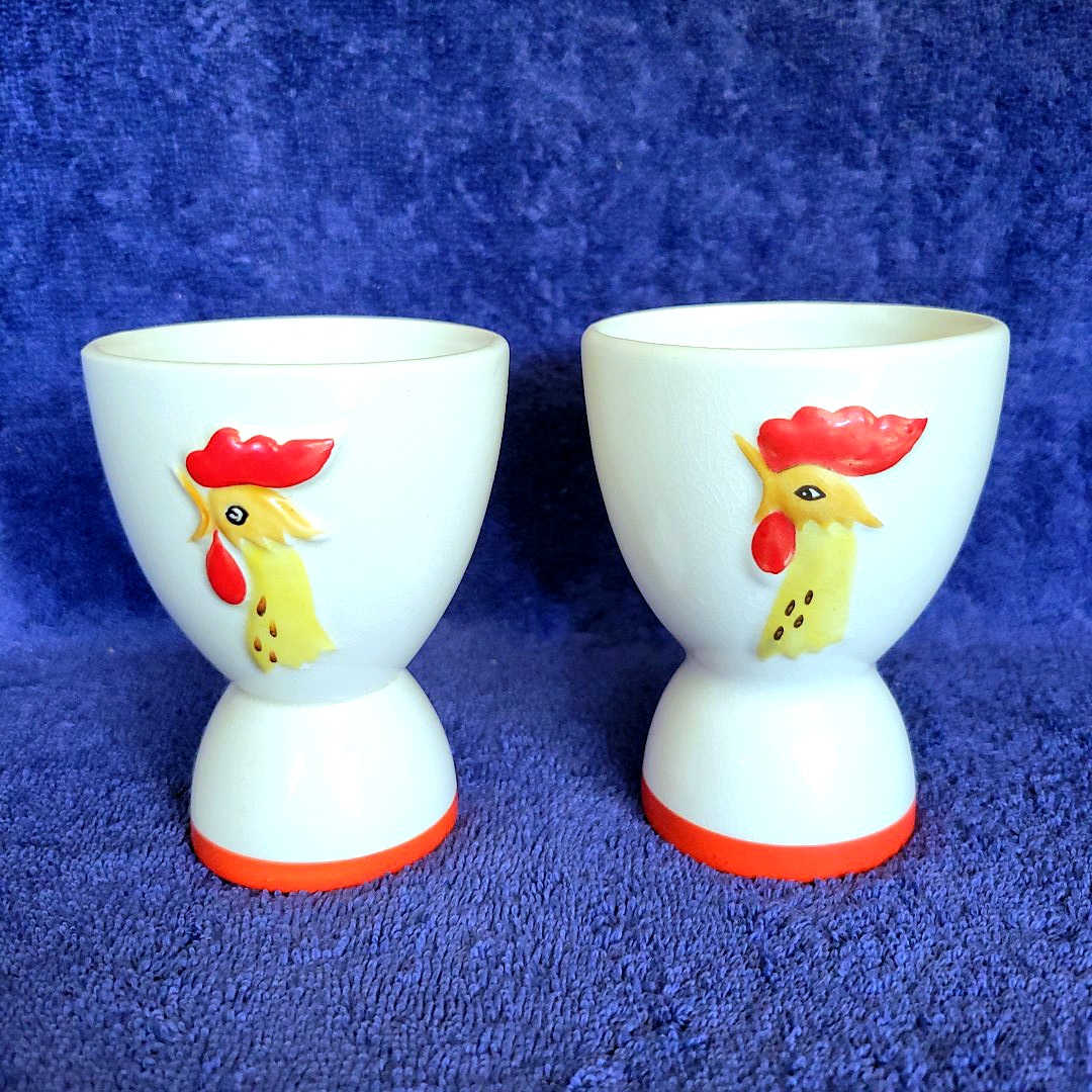 Side-by-side comparison of reversible and single-sided Holt Howard Coq Rouge egg cups.