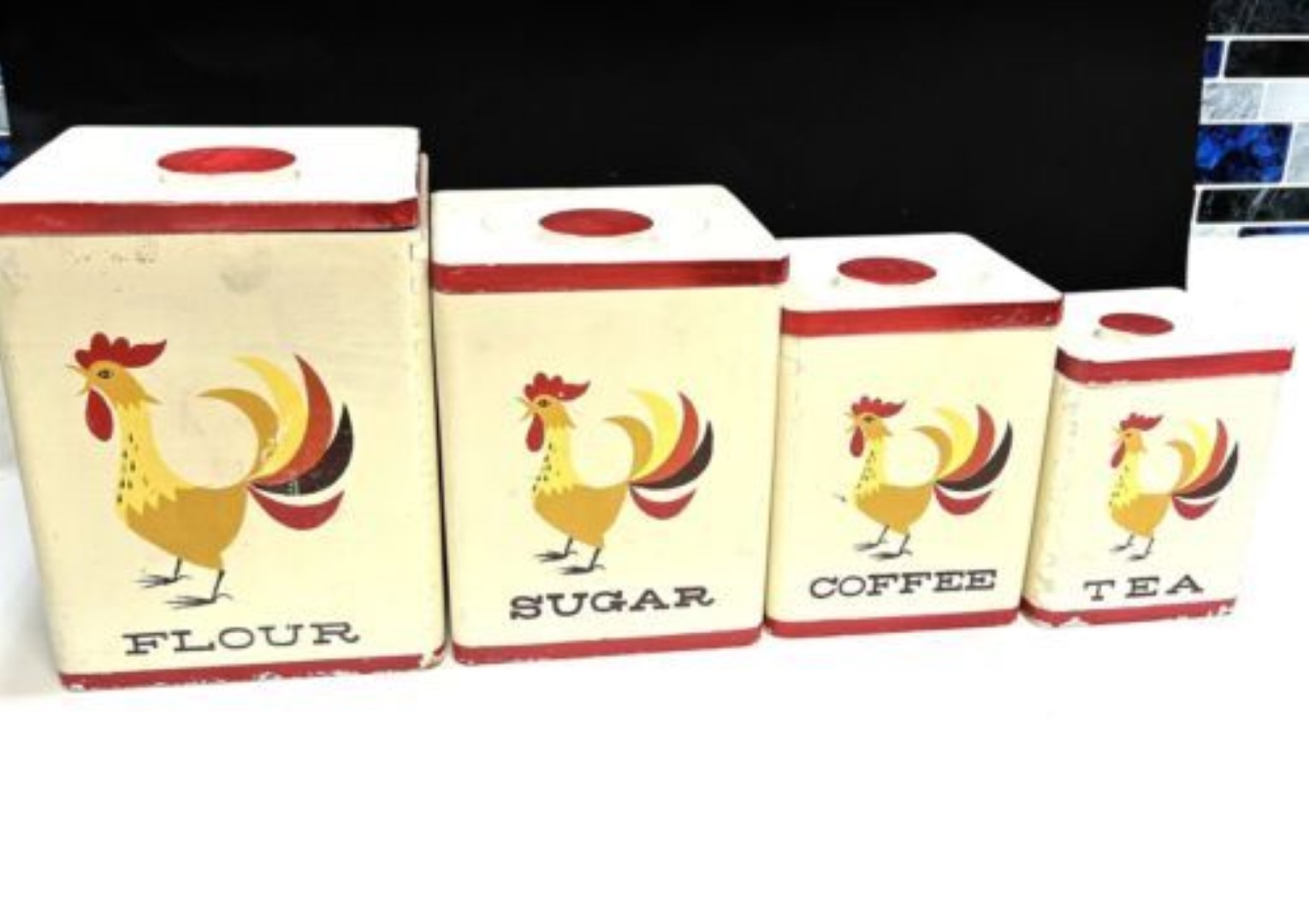Four-piece Coq Rouge wooden canister set with flour, sugar, coffee, and tea canisters.