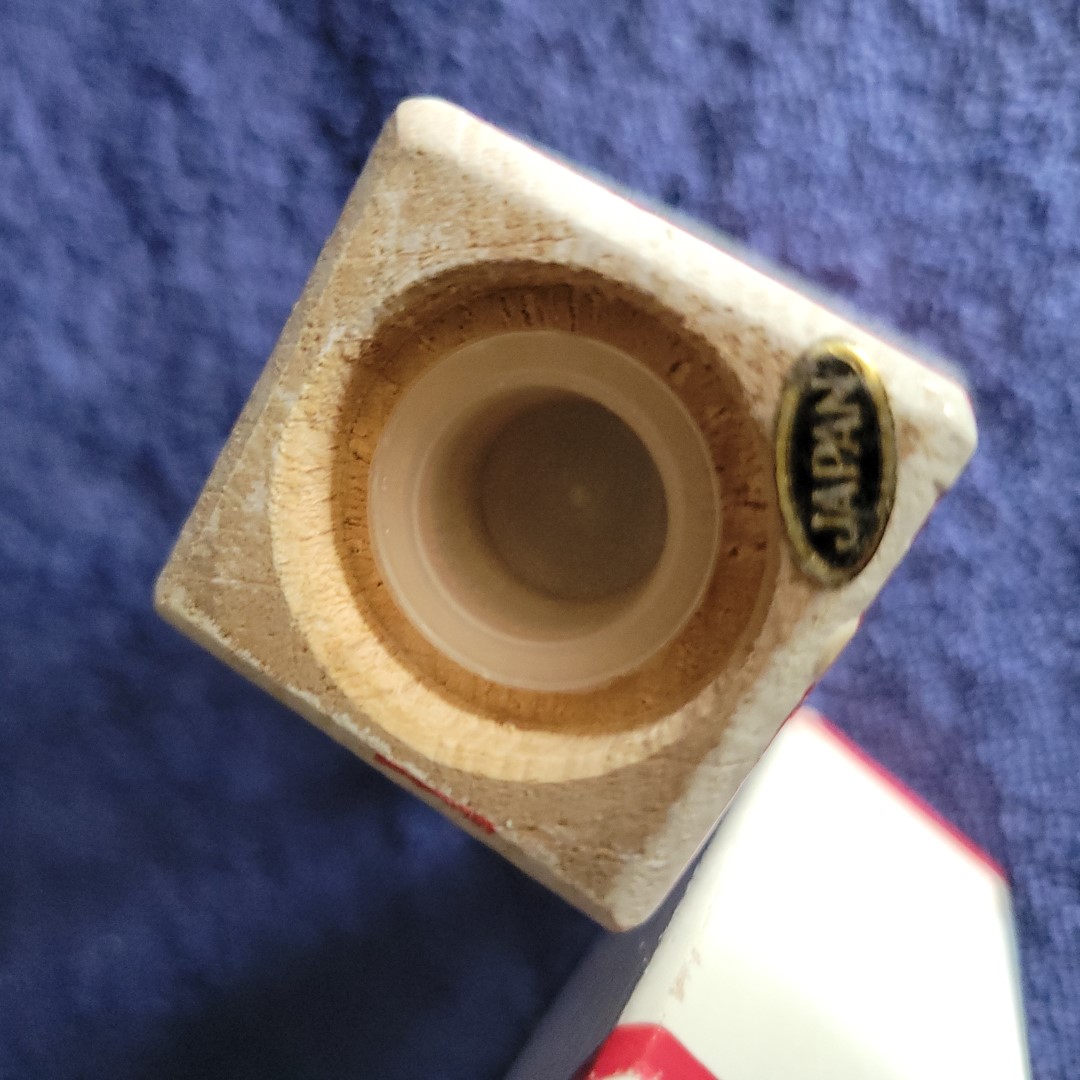 Detail of the bottom of a Coq Rouge wooden salt or pepper shaker showing the JAPAN label.