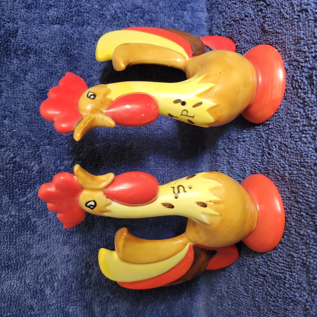 Top view of the larger Coq Rouge rooster salt and pepper shaker set with S and P lettering on the chests.