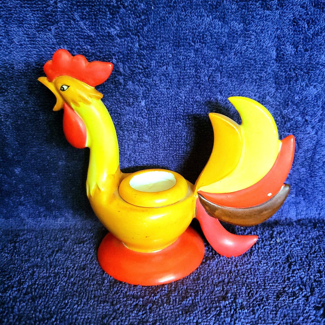 Side view of a Holt Howard Coq Rouge rooster candle holder.
