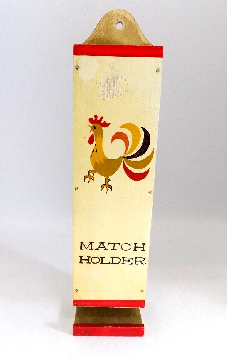 Front view of a complete Holt Howard Coq Rouge wooden match holder with red-painted dispensing lip.