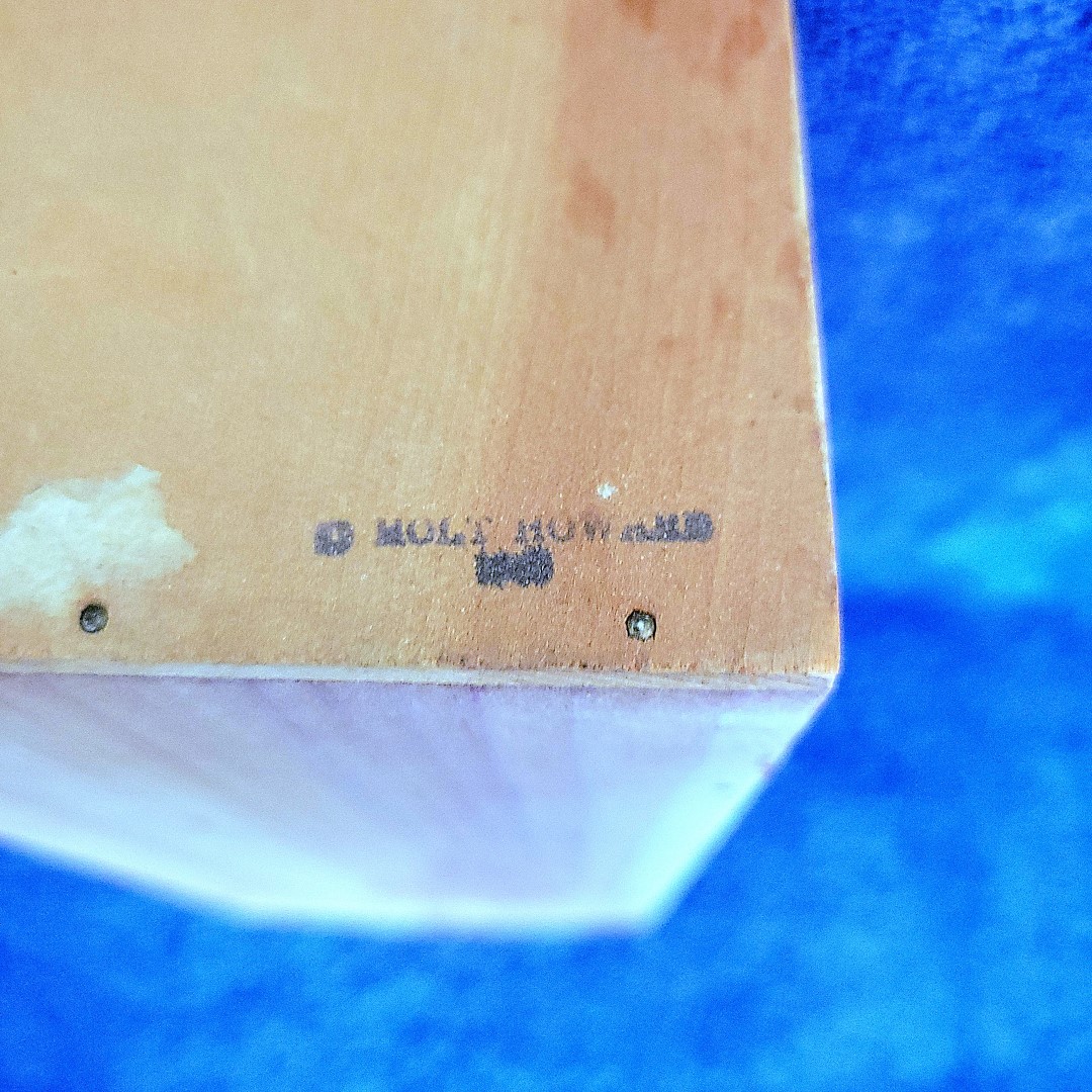 Close-up of Holt Howard marking on the cigarette package holder.