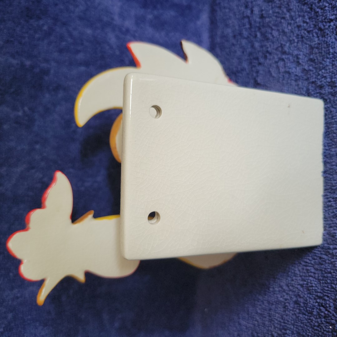 Rear view of Holt Howard Coq Rouge rooster napkin holder with wall mounting holes.