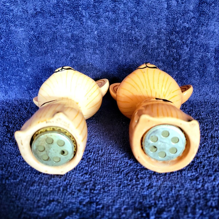 Undersides of Merry Mouse salt and pepper shakers showing squeaker mechanisms.