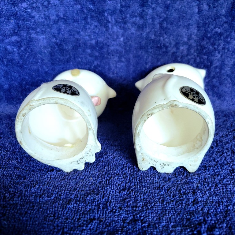 Underside of Cozy Kittens Siamese Cat salt and pepper shakers showing missing squeaker mechanisms and marks.