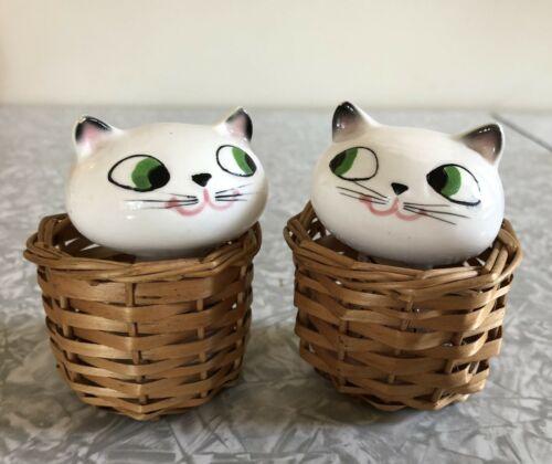 Cozy Kittens Peeking Cats in Baskets salt and pepper shakers seated in wicker baskets.