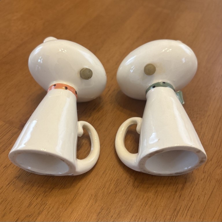Rear and underside view of Winky-Blinky Meow salt and pepper shakers showing refill corks and hollow bases.