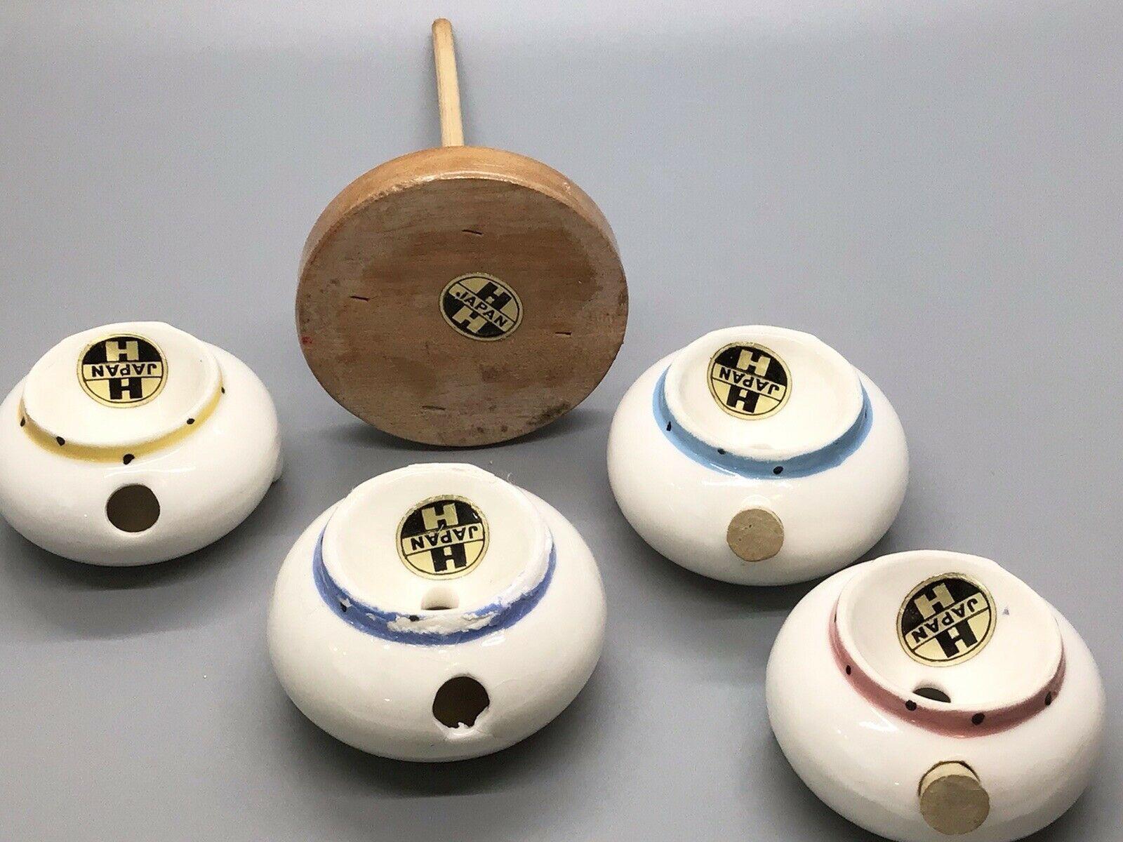 Undersides of Cozy Kittens Stacking Seasons pieces and wooden base with Holt-Howard Japan foil labels.
