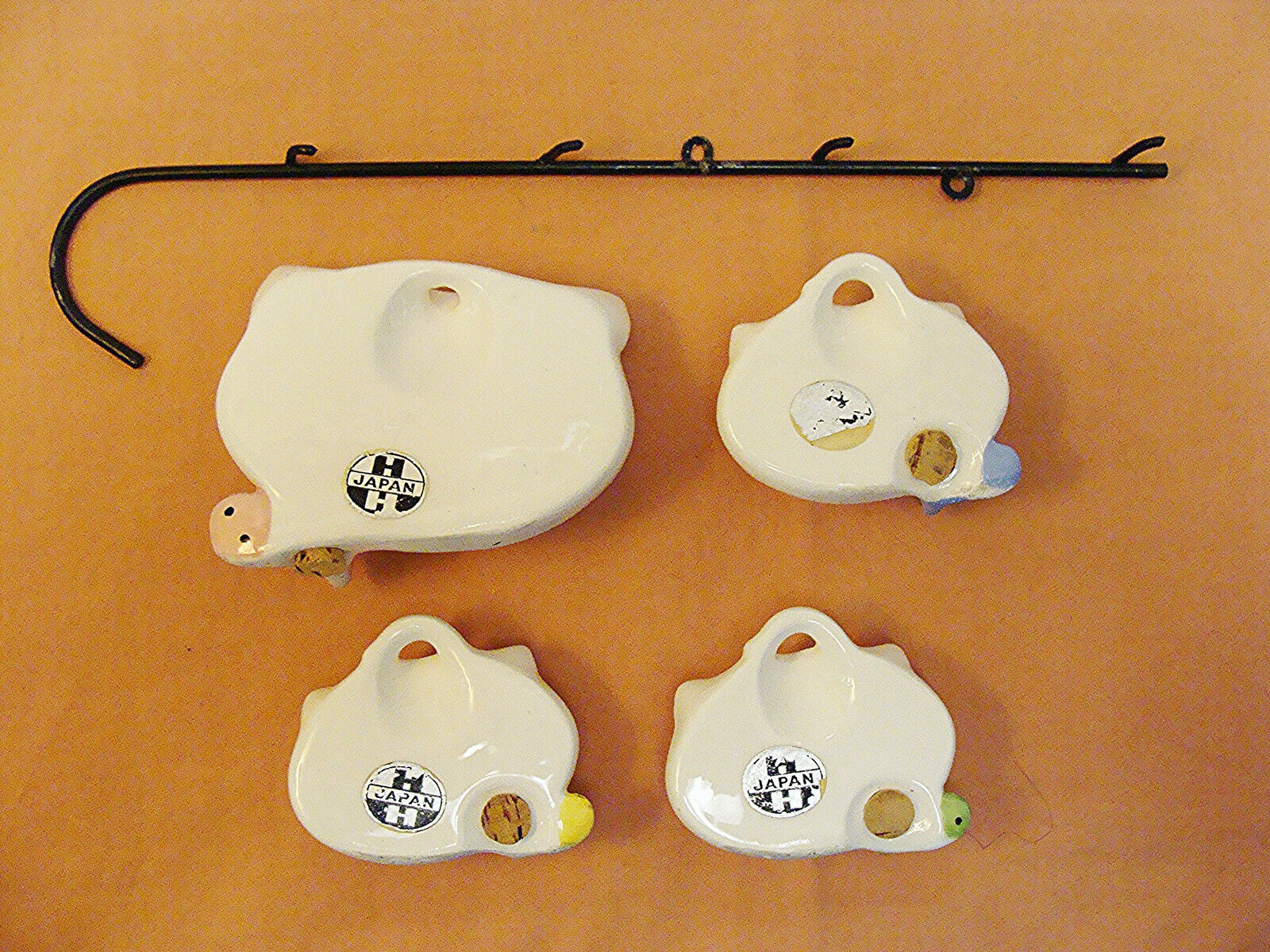 Rear view of Cozy Kittens spice pieces and metal rack.