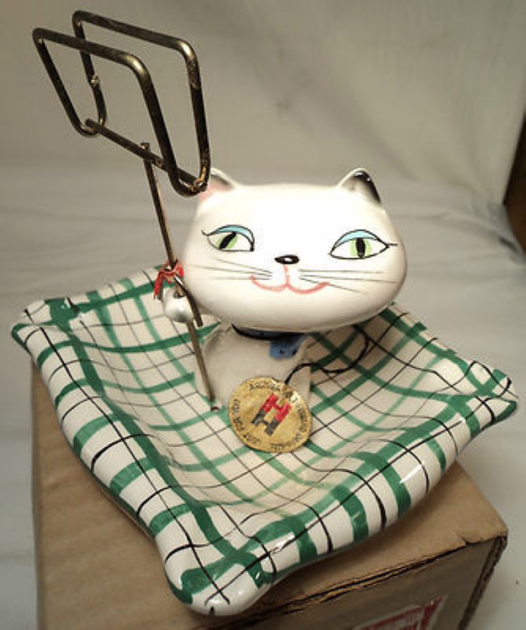 Holt-Howard Cozy Kittens ashtray with match holder on green plaid tray.