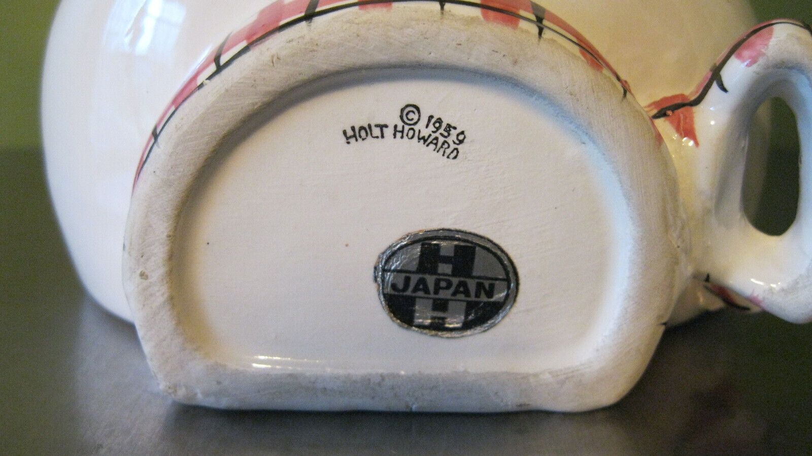 Underside of sideways-looking Cozy Kittens string holder marked 1959 Holt-Howard.