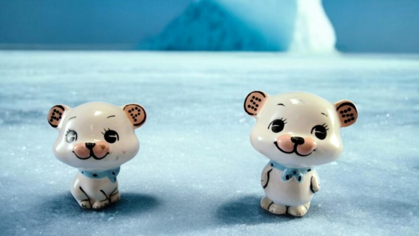 Two Holt-Howard Kitchen Cubs salt-and-pepper shakers posed in a snowy Arctic scene.