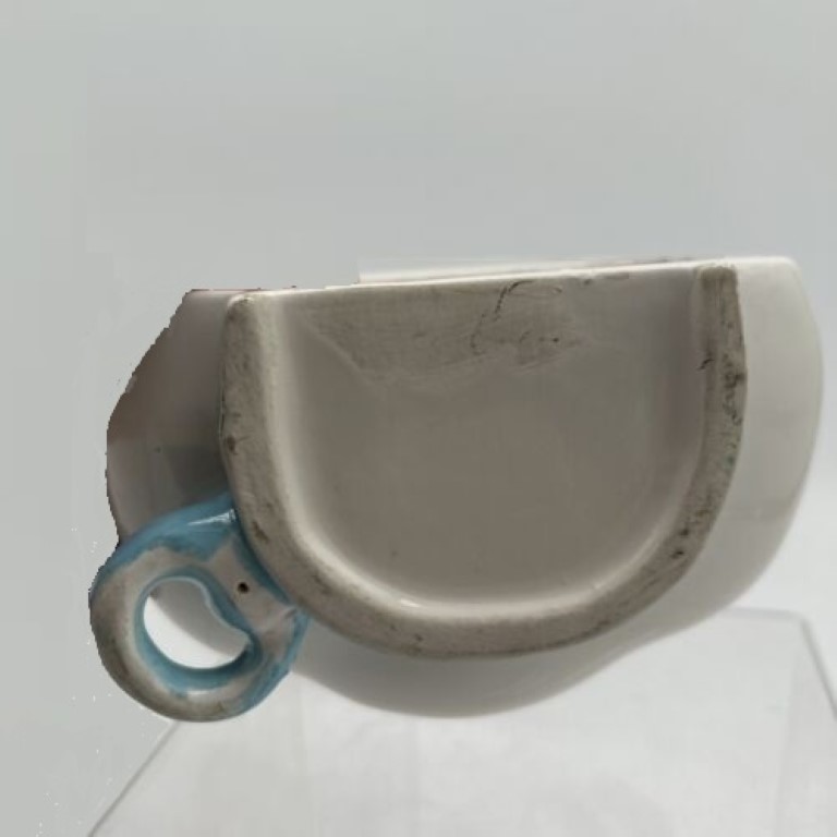 Underside and scarf loop of Kitchen Cubs polar bear string holder.